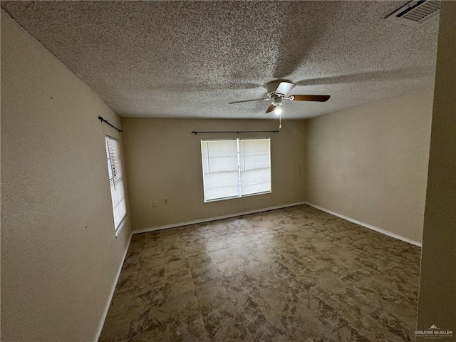 spare room with ceiling fan and a textured ceiling