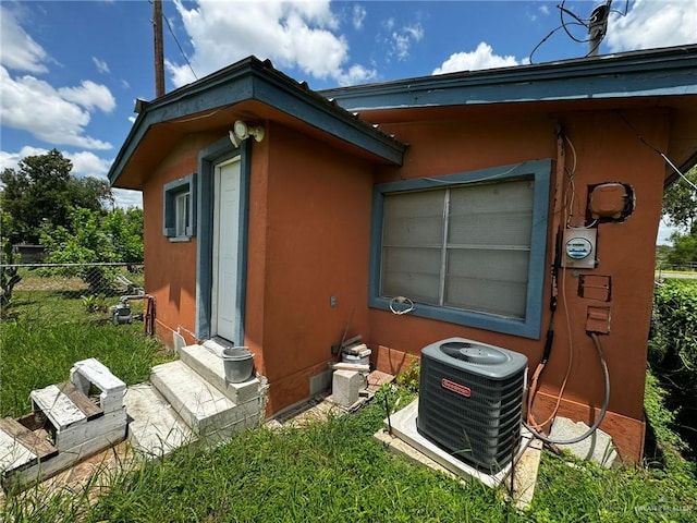 view of side of home with central AC unit