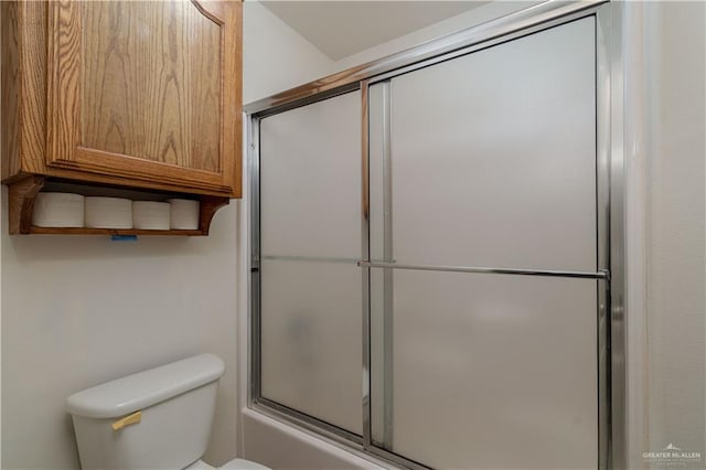 bathroom with shower / bath combination with glass door and toilet