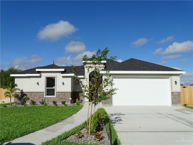 view of front of property featuring a front yard and a garage