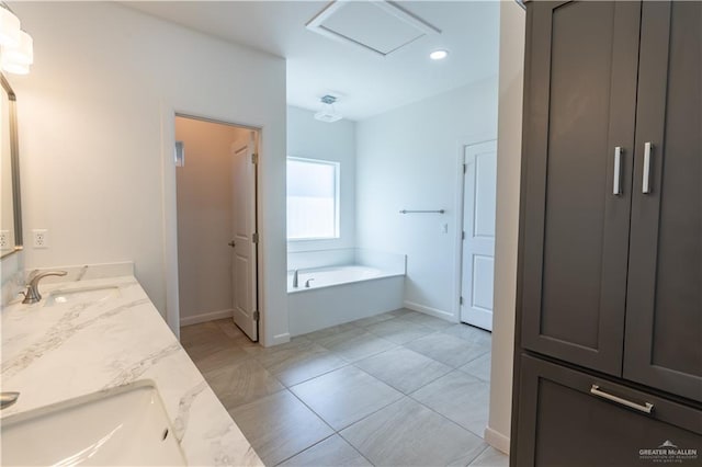 bathroom featuring vanity, tile patterned floors, and a bathtub