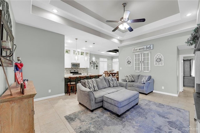 3601 Stratosphere Dr, Edinburg, TX 78539 - living area with a tray ceiling, a ceiling fan, light tile patterned flooring, and recessed lighting