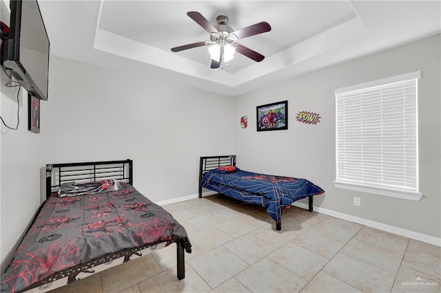 3601 Stratosphere Dr, Edinburg, TX 78539 - bedroom featuring a raised ceiling, ceiling fan, and light tile patterned floors