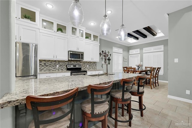 3601 Stratosphere Dr, Edinburg, TX 78539 - kitchen featuring stainless steel appliances, decorative backsplash, white cabinetry, a breakfast bar, and light stone counters