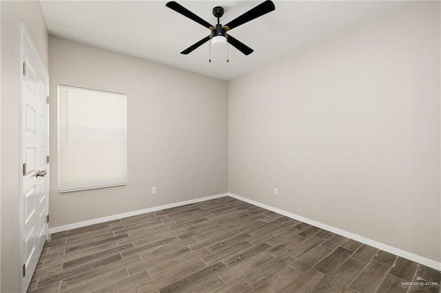 empty room with ceiling fan, baseboards, and dark wood-style flooring