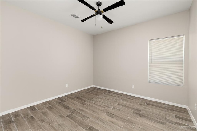 unfurnished room with baseboards, visible vents, ceiling fan, and wood finished floors