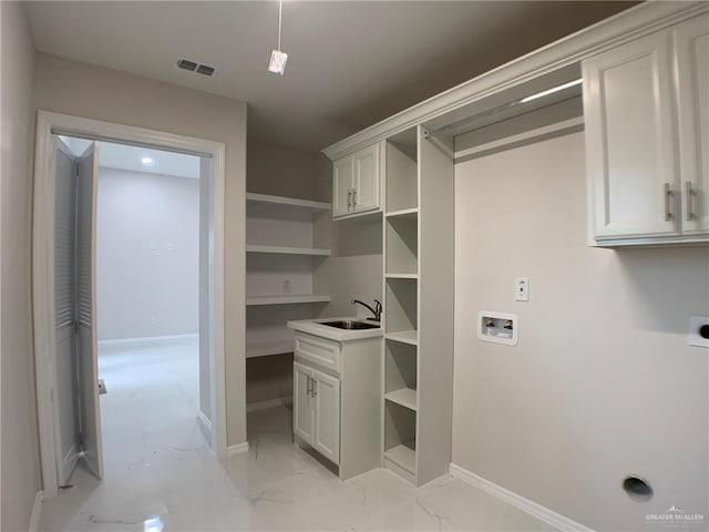 laundry room with washer hookup, cabinets, hookup for an electric dryer, and sink