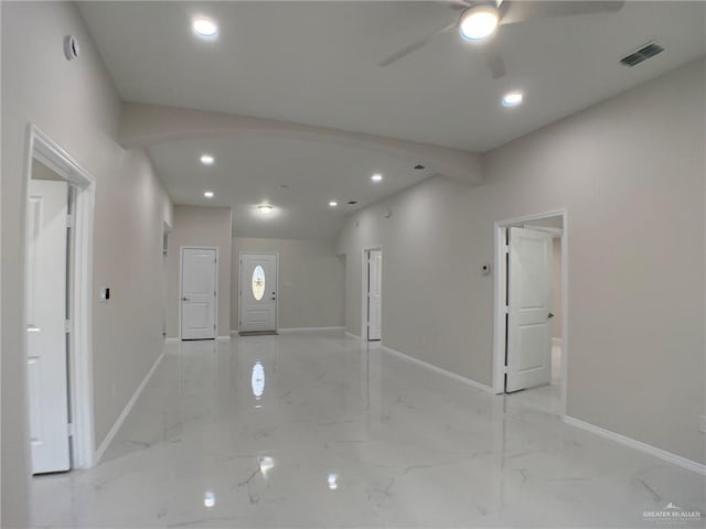 foyer with ceiling fan and vaulted ceiling