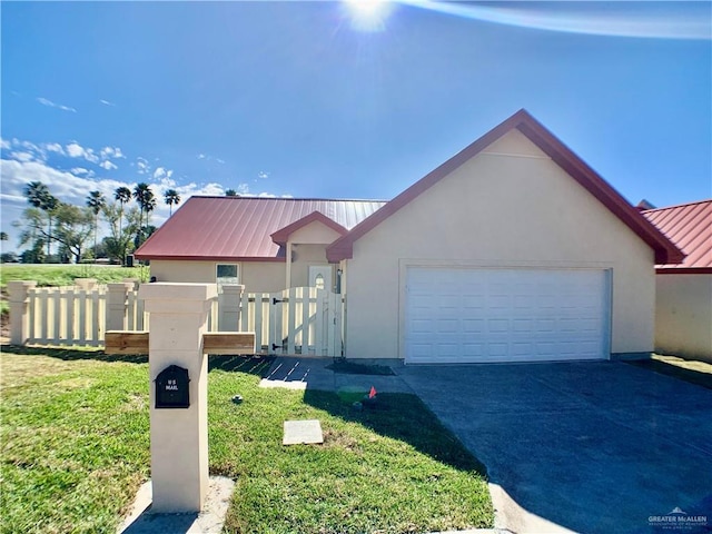 view of front of property with a front yard and a garage