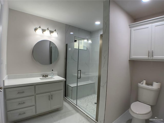 bathroom featuring a shower with shower door, vanity, and toilet