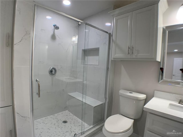 bathroom featuring vanity, toilet, and an enclosed shower