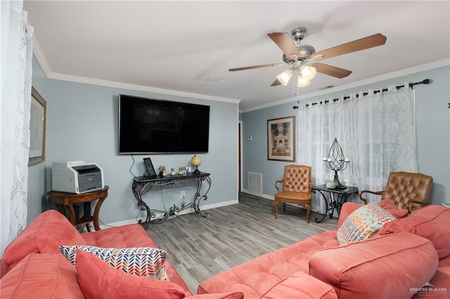 living room featuring crown molding, ceiling fan, and light wood-type flooring