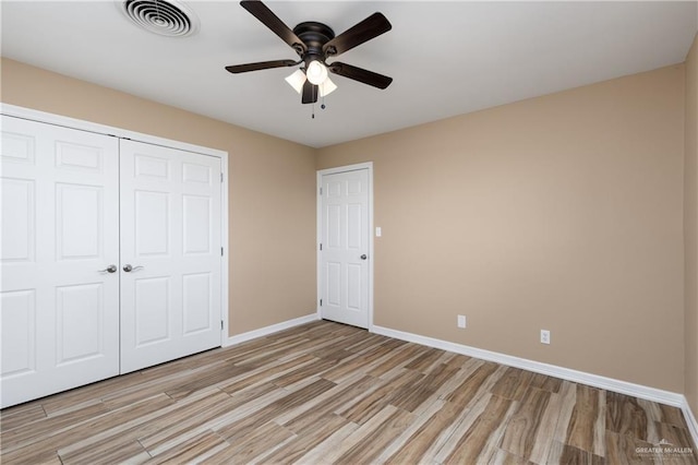 21890 Fm 508, Harlingen, TX 78550 - unfurnished bedroom with light wood finished floors, a closet, and a ceiling fan