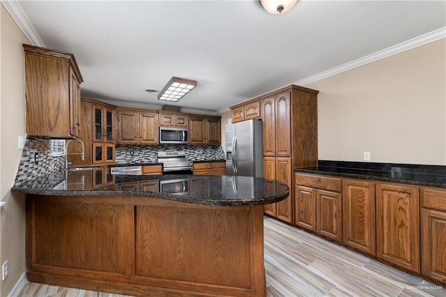 21890 Fm 508, Harlingen, TX 78550 - kitchen with appliances with stainless steel finishes, tasteful backsplash, ornamental molding, a peninsula, and glass insert cabinets