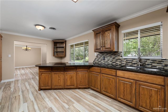 21890 Fm 508, Harlingen, TX 78550 - kitchen featuring plenty of natural light, backsplash, crown molding, dark stone counters, and a chandelier