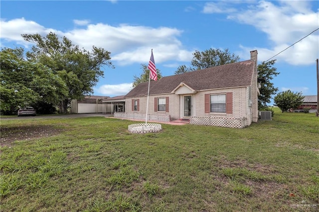 ranch-style home featuring a front yard and central air condition unit