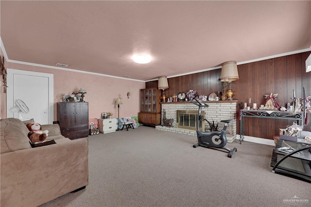 living room featuring carpet floors, crown molding, wooden walls, and a brick fireplace