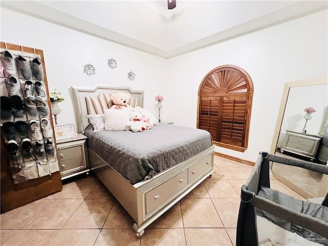bedroom with ceiling fan and light tile patterned floors
