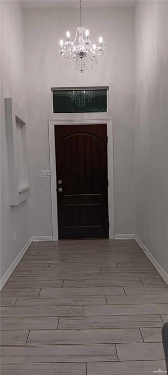 entryway with a notable chandelier and light hardwood / wood-style flooring