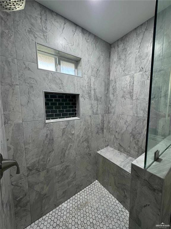 bathroom with a tile shower