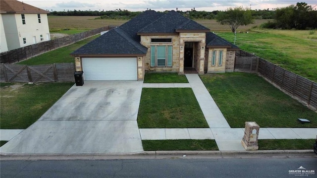 view of front of house featuring a garage and a front yard