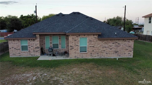 back of property with a patio area and a lawn