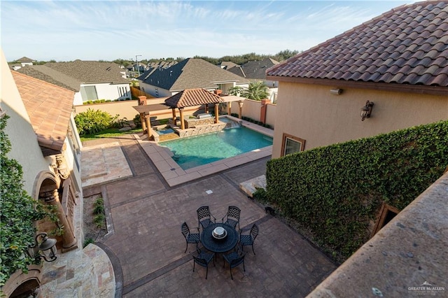 view of swimming pool featuring a patio area, fence, a fenced in pool, and a gazebo