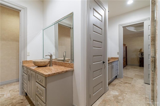 bathroom featuring baseboards and vanity