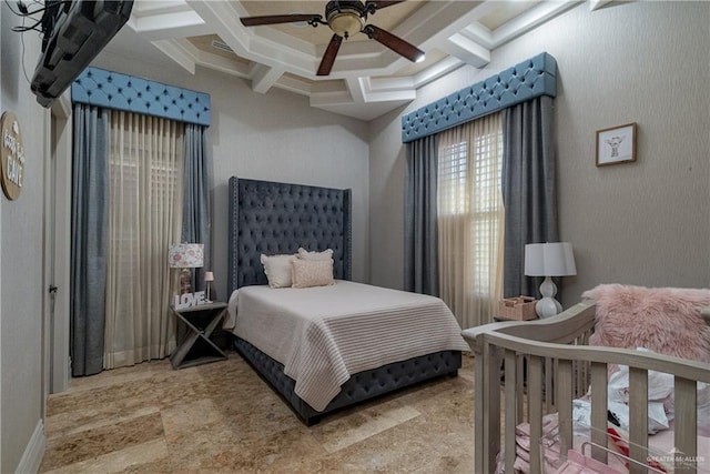 bedroom with beam ceiling, coffered ceiling, and a ceiling fan