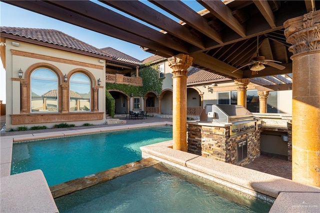 view of pool with ceiling fan, a pool with connected hot tub, exterior kitchen, grilling area, and a patio area