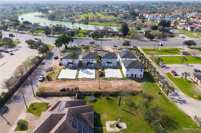 bird's eye view featuring a water view and a residential view