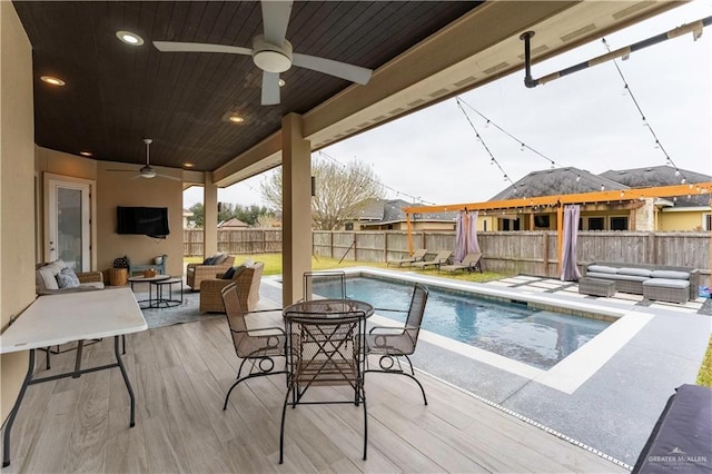 view of pool featuring a fenced in pool, a fenced backyard, an outdoor living space, and a ceiling fan