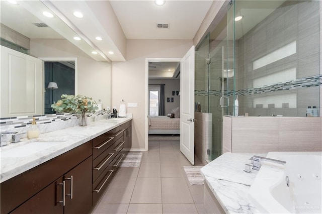 bathroom featuring tile patterned flooring, visible vents, connected bathroom, and a sink