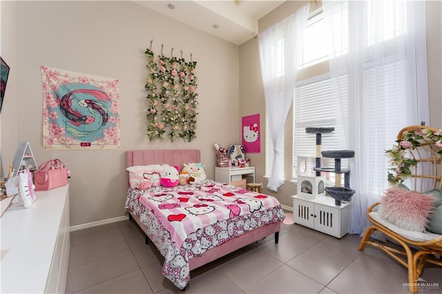 bedroom with baseboards and tile patterned floors