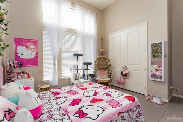 bedroom with a closet, multiple windows, and light tile patterned floors