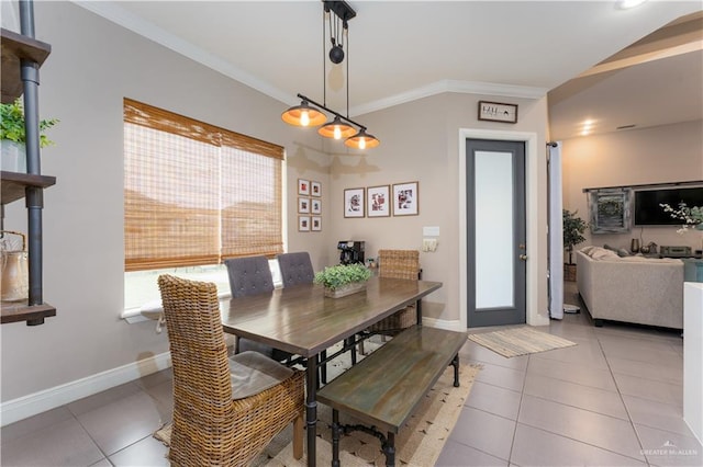 dining space with baseboards, light tile patterned flooring, and crown molding