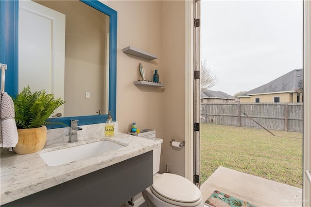 bathroom with toilet and vanity