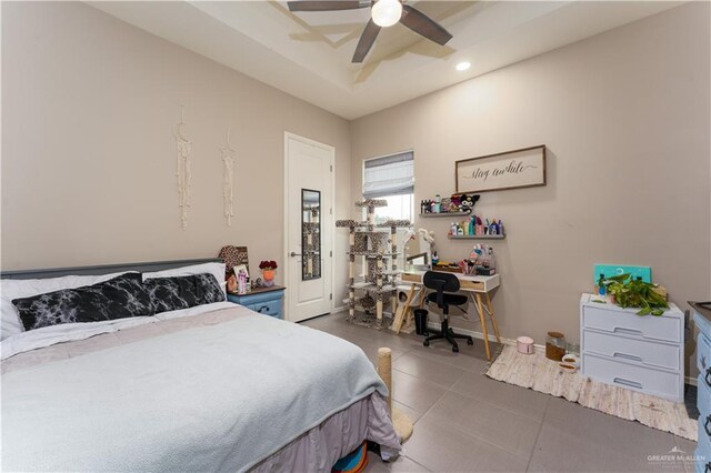 bedroom with ceiling fan, dark tile patterned flooring, a raised ceiling, and recessed lighting