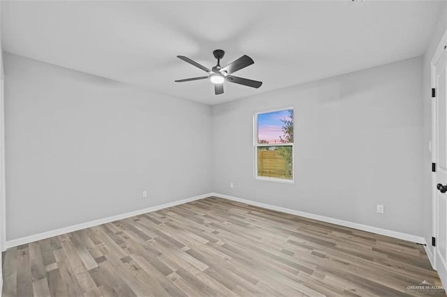 spare room featuring light hardwood / wood-style floors and ceiling fan