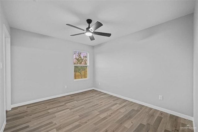 spare room featuring light hardwood / wood-style flooring and ceiling fan