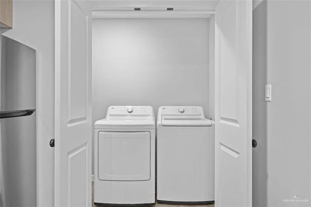 laundry area with washing machine and clothes dryer