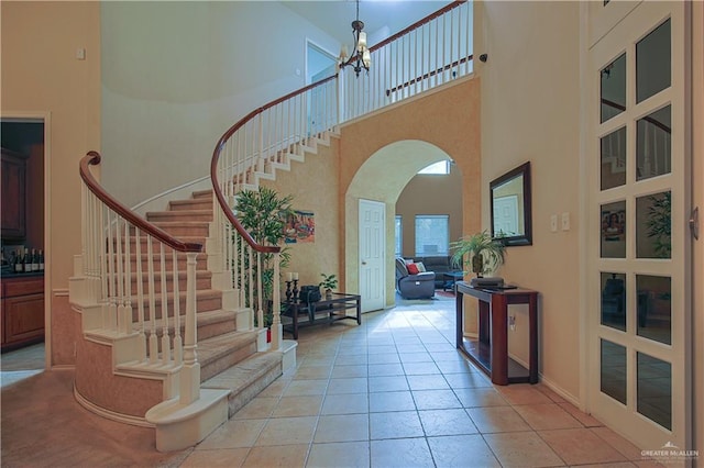 tiled foyer featuring a high ceiling