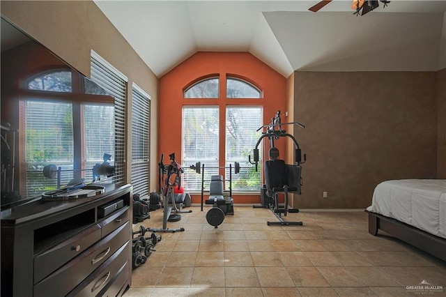 exercise room with light tile patterned floors, ceiling fan, and lofted ceiling