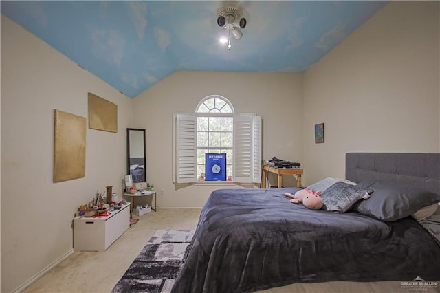 bedroom featuring light colored carpet and vaulted ceiling