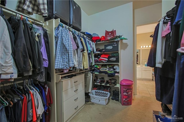 spacious closet featuring light colored carpet