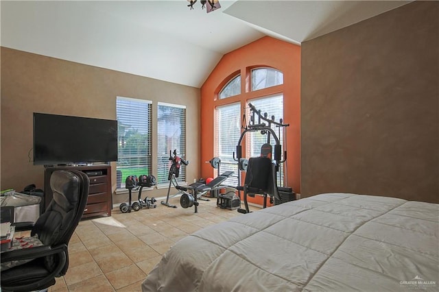 tiled bedroom featuring vaulted ceiling