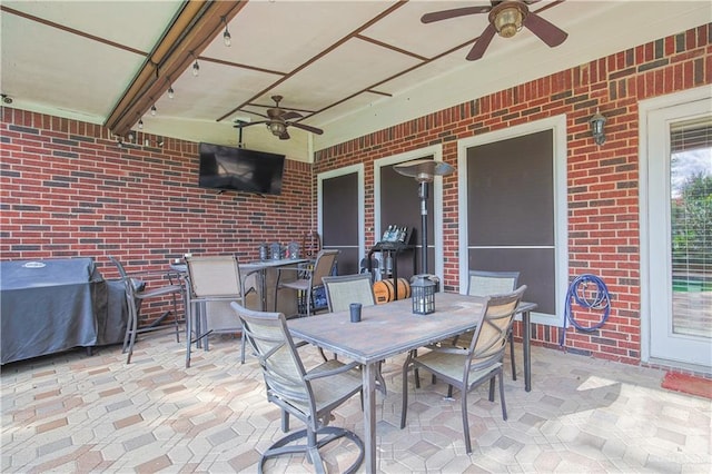 view of patio featuring ceiling fan and a grill