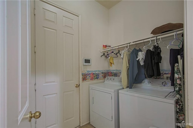 clothes washing area featuring washing machine and clothes dryer