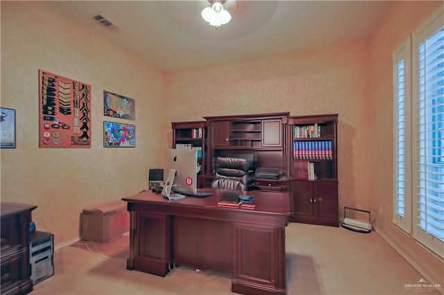 carpeted home office with ceiling fan