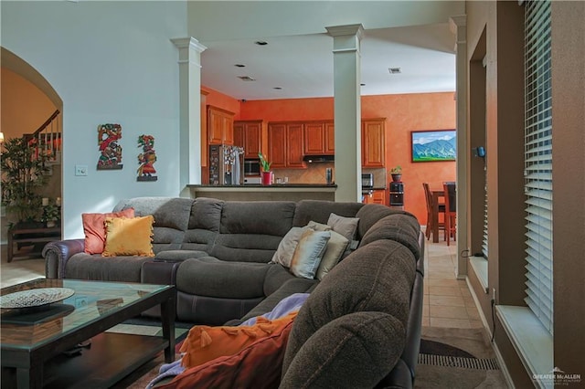 tiled living room featuring ornate columns